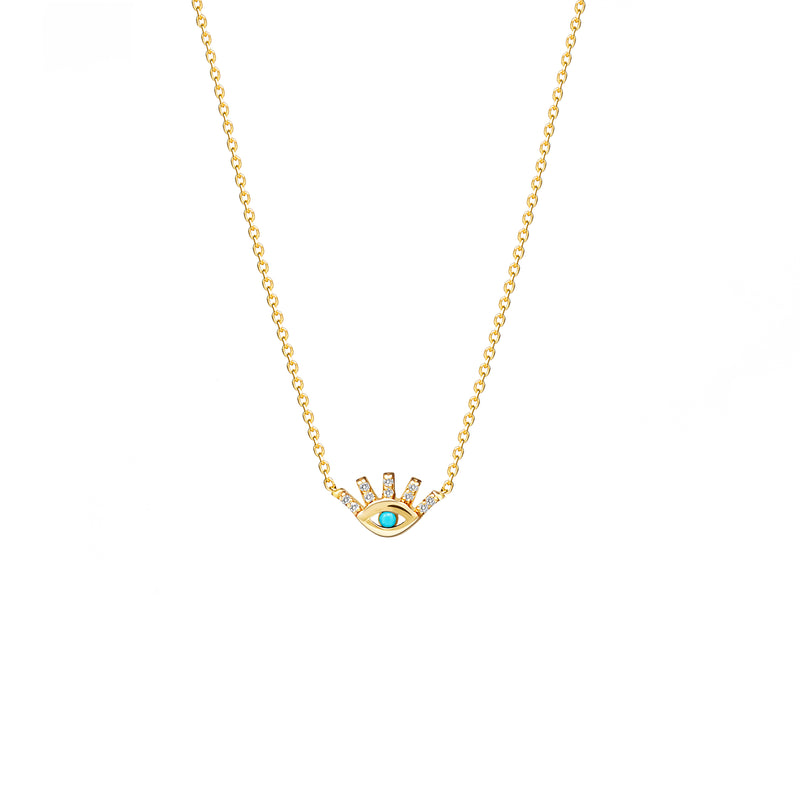 This 14 karat gold necklace with diamonds featuring a protection eye is our dream jewelry piece. The pendant features pave set diamonds on the lashes and a hand set turquoise stone in the center of the eye.
