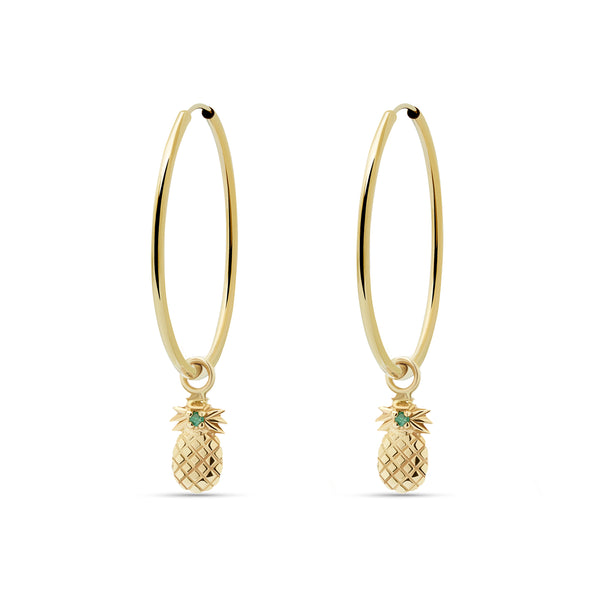 A two piece 14 karat gold hoop earring featuring the pineapple charm with a handset green sapphire stone. 