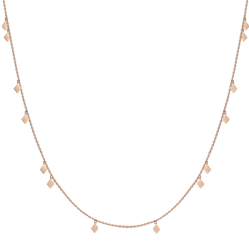 This delicate and playful 14 karat gold necklace features dangling tribal gold charms. Its simple style mixes and matches easily with other jewels and is the perfect accessory for a layering look.
