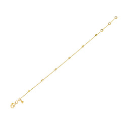 This gold anklet for day to night wear is made of 14 karat gold. The anklet features solid gold balls aligned on a delicate gold chain.