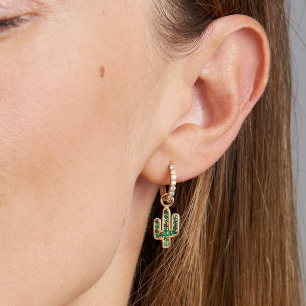 These extravagant charms in 14 karat gold featuring a Cactus are handset with emerald gemstones. The two charms are different and add a playful and unique look to your eargame. Wear these charms on our Diamond Huggies or Essential Hoops. Also available in rose gold.
