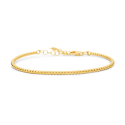 A delicate, yet solid Bangle Bracelet made of lined up gold balls. It is an essential bangle bracelet that is perfect for every day wear. Its chain and lock on the back side make this bracelet super comfortable and safe to wear.