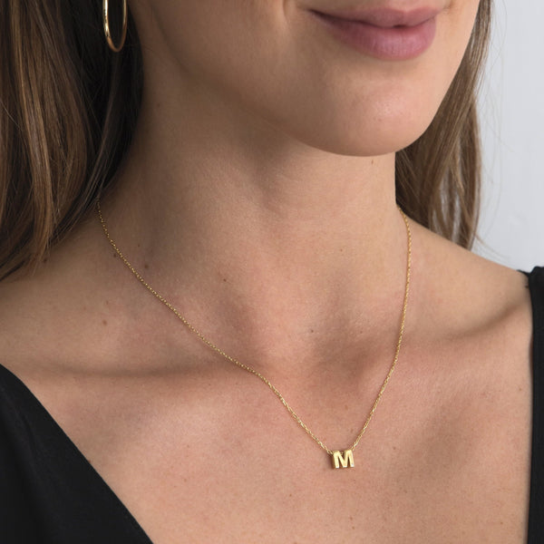 A 18 karat gold vermeil necklace with your initial letter "M". This diamond letter necklace is a special jewelry necklace that can be worn day and night. A genuine diamond stone in the corner of the letter makes this gold diamond necklace a luxury and ideal gift for yourself, your best friend or loved one.