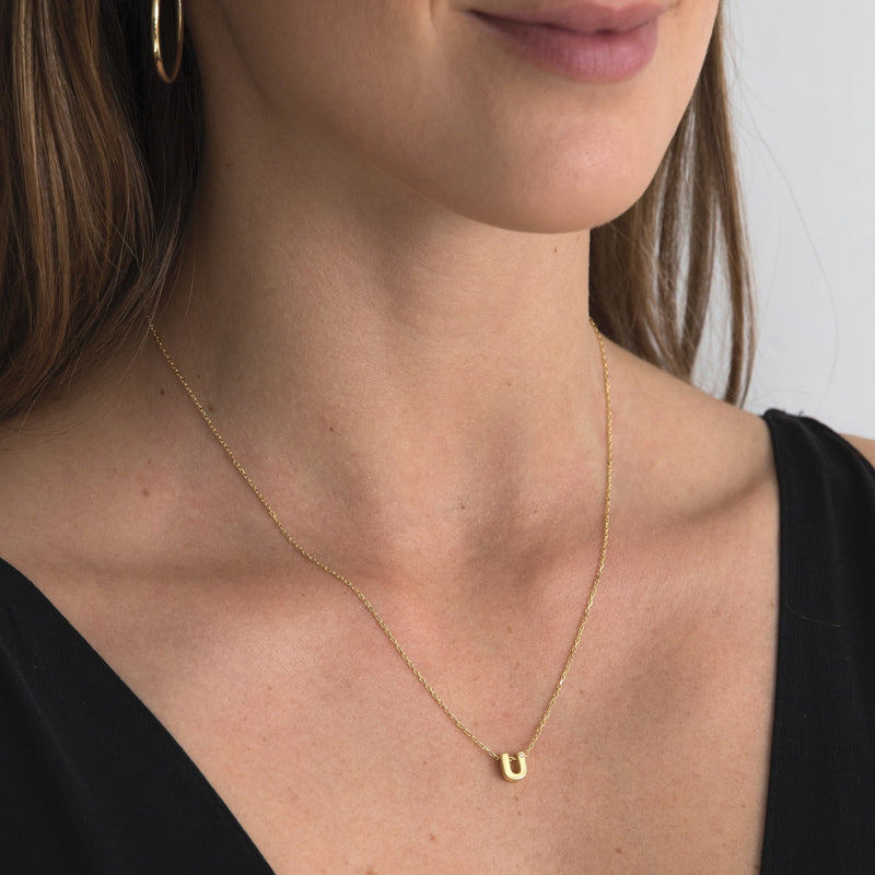 A 18 karat gold vermeil necklace with your initial letter "U". This diamond letter necklace is a special gold necklace that can be worn day and night. A genuine diamond stone in the corner of the letter makes this gold diamond necklace a luxury and ideal gift for yourself, your best friend or loved one.