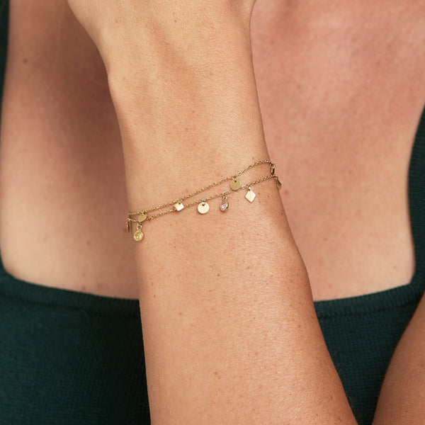 This double chain 14 karat gold bracelet is one of our bestsellers!  The handmade double chain bracelet with all its shimmer, colours and little charms is light and fits your wrist perfectly. Complete the look with the matching Nomad Necklace and Nomad Anklet. The gold bracelet length is 16cm extendable to 18cm.